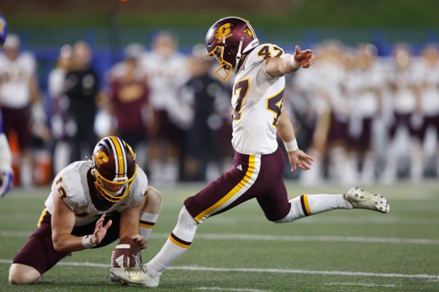 Central Michigan place kicker Cade Graham (47) makes a field...