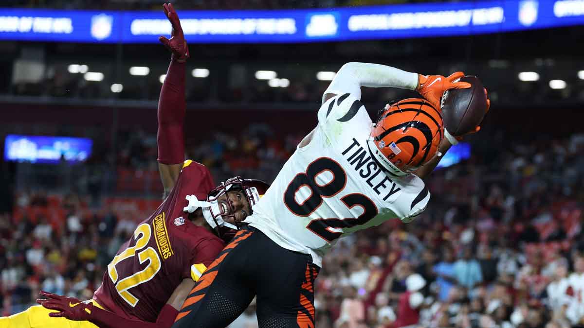 Cincinnati Bengals wide receiver Mitchell Tinsley (82) catches a touchdown pass over Washington Commanders cornerback Car'lin Vigers (22) during the first half at Northwest Stadium.