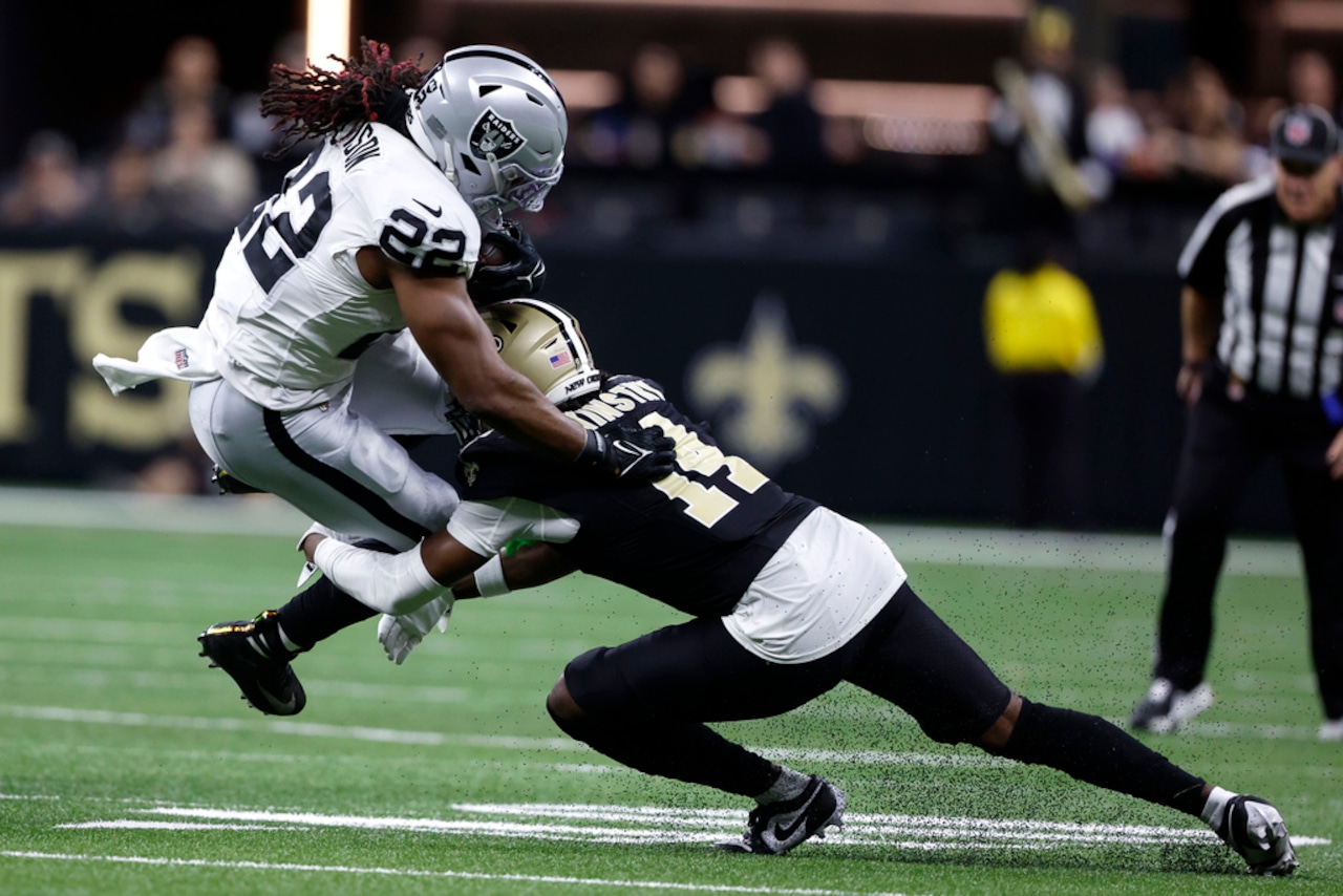 New Orleans cornerback Kool-Aid McKinstry tackles Las Vegas Raiders running back Alexander Mattison during an NFL game on Dec. 29, 2024, at Caesars Superdome in New Orleans.