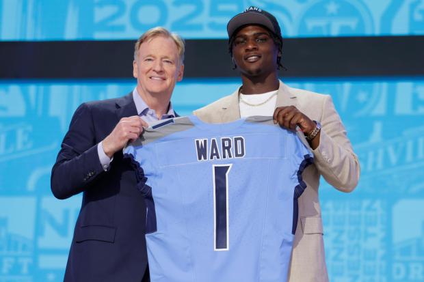 Miami quarterback Cam Ward, right, poses with NFL Commissioner Roger Goodell after being chosen by the Tennessee Titans with the first overall pick during the first round of the NFL football draft, Thursday, April 24, 2025, in Green Bay, Wis. (AP Photo/Matt Ludtke)