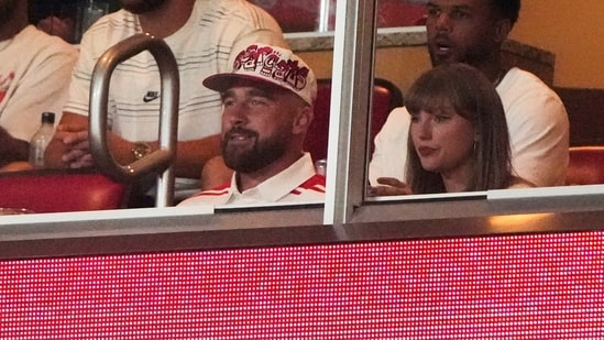 Taylor Swift, front right, sits with fiance Travis Kelce.(AP)