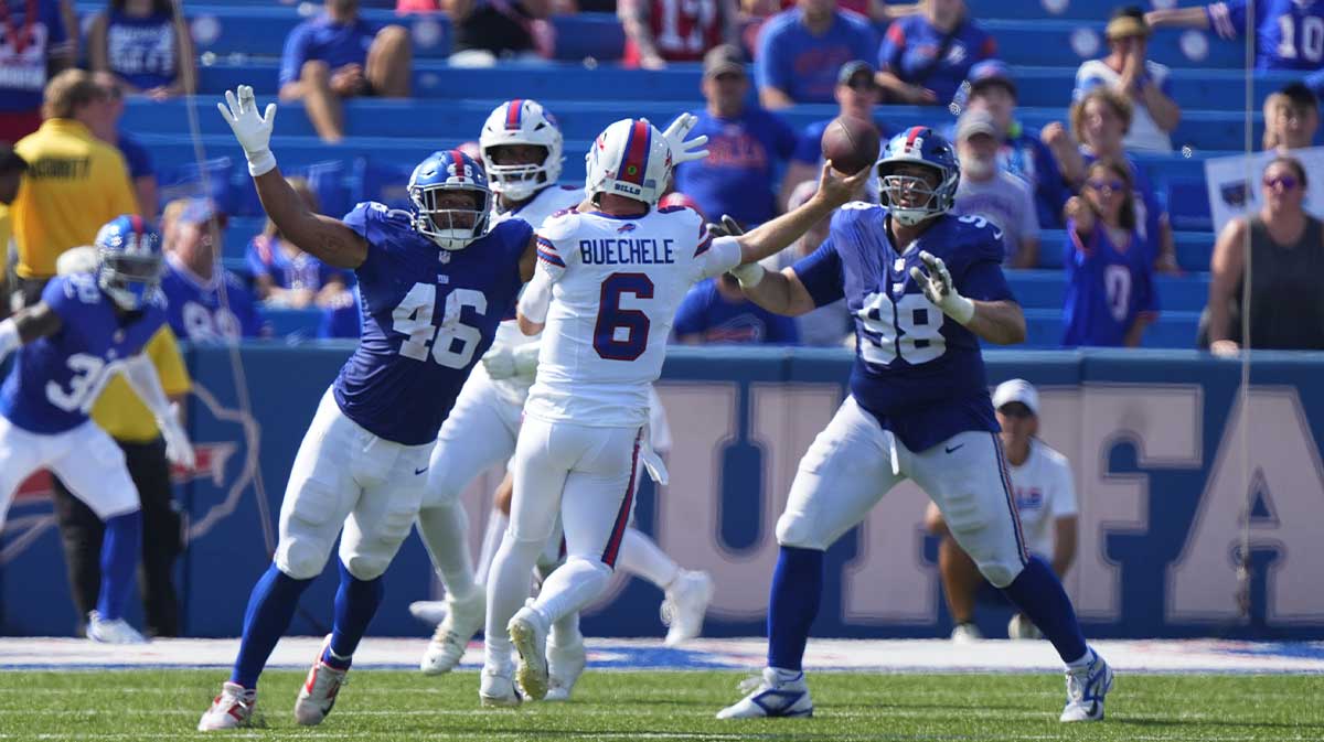 Aug 9, 2025; Orchard Park, New York, USA; New York Giants linebacker Trace Ford (46) and New York Giants defensive tackle D.J. Davidson (98) defend against Buffalo Bills quarterback Shane Buechele (6) throwing the ball during the second half at Highmark Stadium. Mandatory Credit: Gregory Fisher-Imagn Images