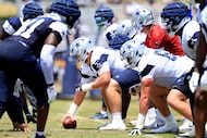 Dallas Cowboys center Cooper Beebe (56) prepares to snap the ball during a training camp...