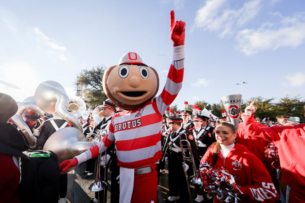 FILE - Brutus, the Ohio State mascot, stands with members of the band outside AT&T Stadium...