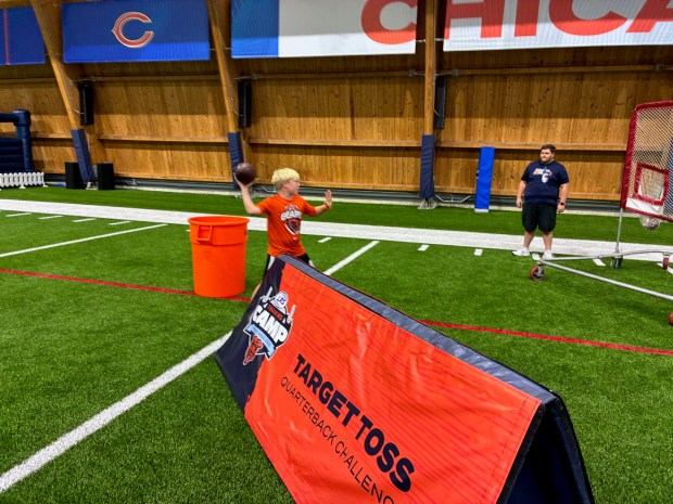 Rex Schramek, 9, of San Antonio, Texas, tosses a football at the Walter Payton Center in Lake Forest. (Daniel I. Dorfman/ for the Pioneer Press)