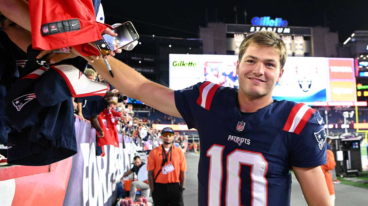New England Patriots quarterback Drake Maye (10) signs autographs after a game against the Washington Commanders during the second half at Gillette Stadium