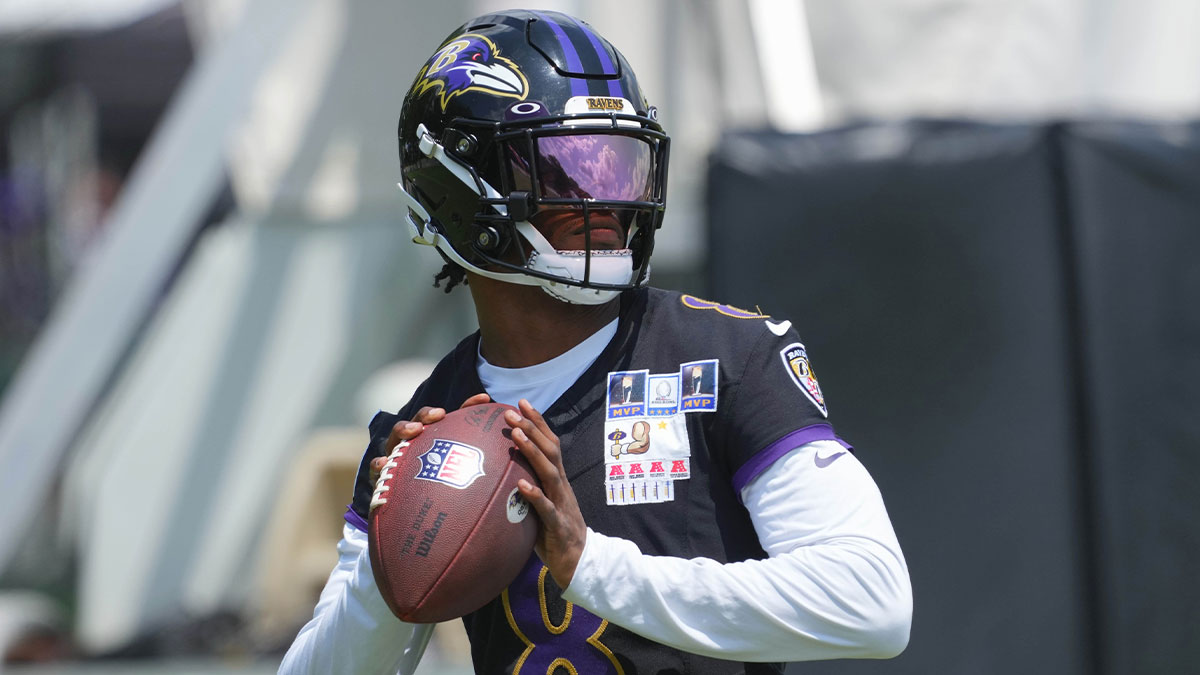 Baltimore Ravens quarterback Lamar Jackson (8) warms up during training camp at Under Armour Performance Center.
