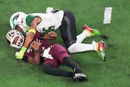 Humble Summer Creek quarterback Blake Thomas (2) is sacked by DeSoto defensive lineman...