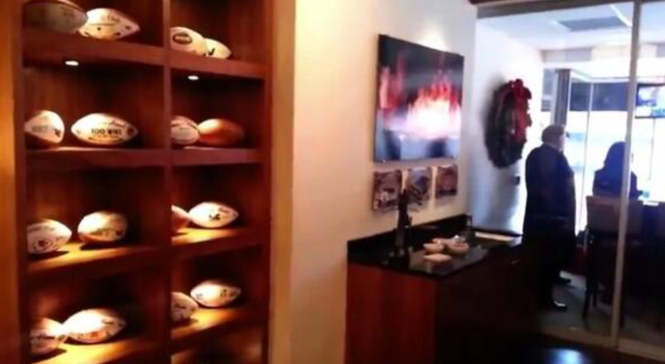 Tons of footballs are located on the walls in the suite
