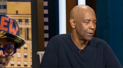 Screenshot of a man in a dark shirt being interviewed.