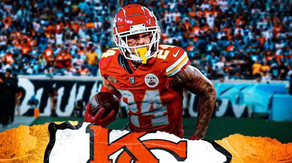 Chiefs' Skyy Moore sitting on an NFL sideline looking serious.