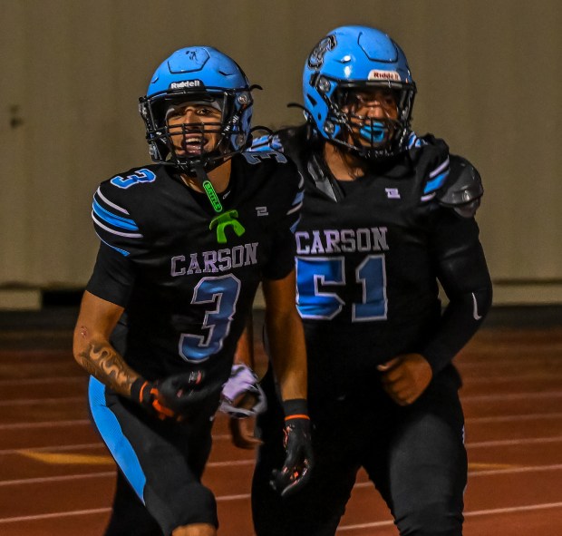 Carson High celebrates their third touchdown during the Colts’ game...