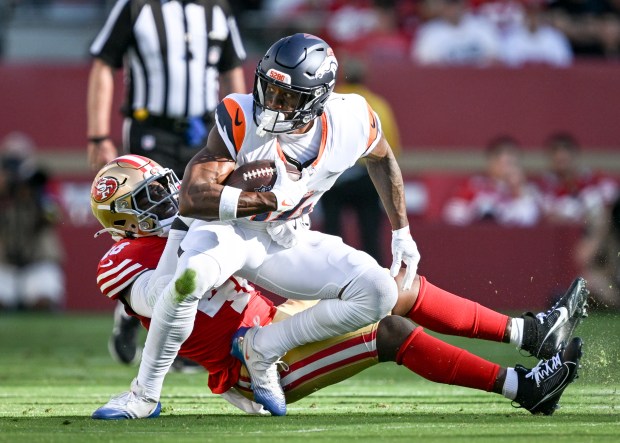 Tatum Bethune (48) of the San Francisco 49ers pulls down Courtland Sutton (14) of the Denver Broncos during the first quarter at Levi's Stadium in Santa Clara, California on Saturday, Aug. 9, 2025. (Photo by AAron Ontiveroz/The Denver Post)