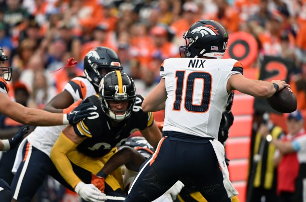Bo Nix (10) of the Denver Broncos looks to pass the ball under pressure from T.J. Watt (90) of the Pittsburgh Steelers during the second half of the Denver Broncos game at Empower Field at Mile High in Denver on Sept. 15, 2024. The Broncos took on the Pittsburgh Steelers for game two of the season. The Broncos lost to the Steelers 13-6. (Photo by Helen H. Richardson/The Denver Post)