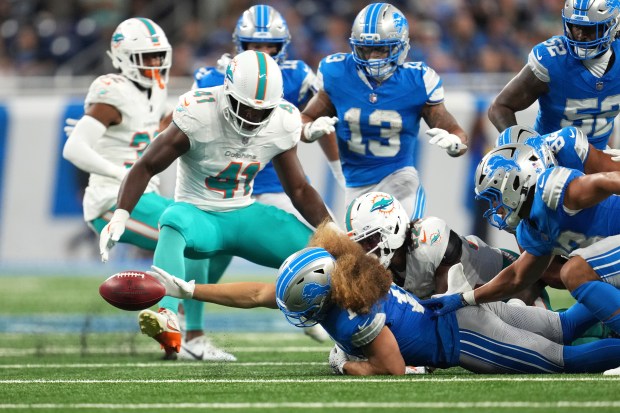 Detroit Lions linebacker Grant Stuard reaches out in vain to...