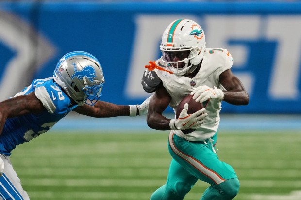 Miami Dolphins wide receiver Tahj Washington carries against Detroit Lions...