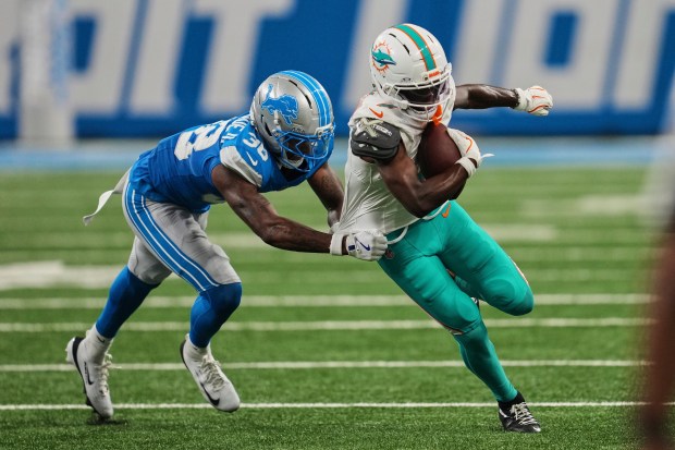 Miami Dolphins wide receiver Tahj Washington carries against Detroit Lions...