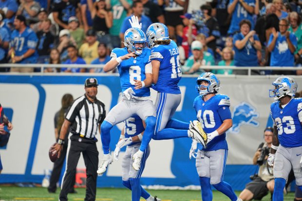 Detroit Lions quarterback Kyle Allen (8) celebrates his touchdown pass...
