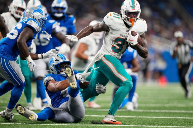 Miami Dolphins running back Ollie Gordon II (31) is tackled...