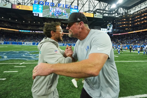 Miami Dolphins head coach Mike McDaniel, left, greets Detroit Lions...