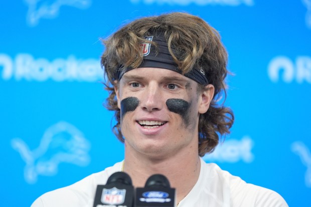 Detroit Lions wide receiver Isaac TeSlaa talks to reporters after...