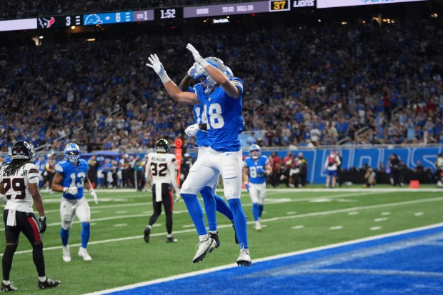 Detroit Lions wide receiver Isaac TeSlaa (18) celebrates with Dominic...