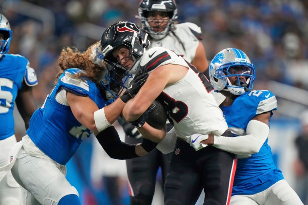 Houston Texans tight end Harrison Bryant, center, is tackled bye...