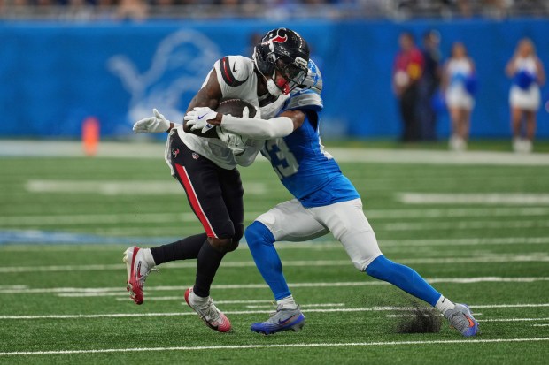 Houston Texans wide receiver Juwann Winfree, left, is tackled by...