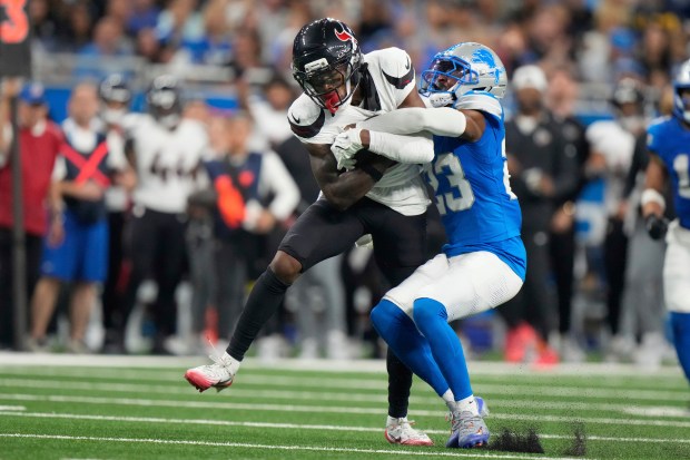 Houston Texans wide receiver Juwann Winfree, left, is tackled why...