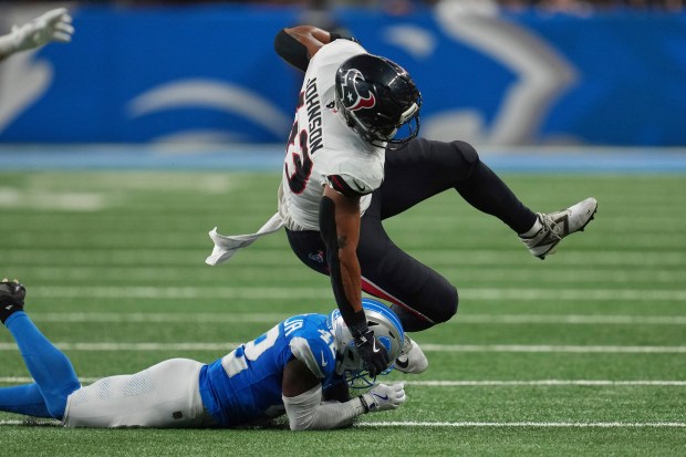 Houston Texans fullback Jakob Johnson (43) is tackled by Detroit...