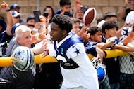 Dallas Cowboys cornerback DaRon Bland (26) slaps hands with fans as he arrives for  training...