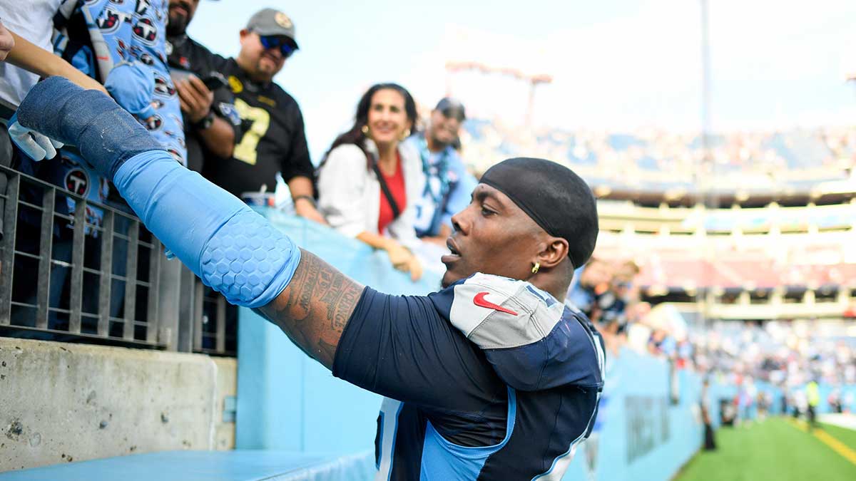 Tennessee Titans safety Quandre Diggs (28) gives a fan his elbow pad against the New England Patriots during post game at Nissan Stadium.
