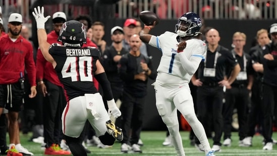 Tennessee Titans quarterback Cameron Ward (1) throws a pass over Atlanta Falcons linebacker JD Bertrand (40) (AP)