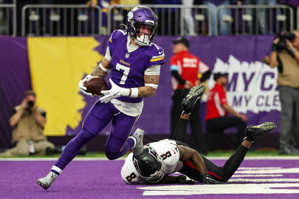 Minnesota Vikings cornerback Byron Murphy Jr. (7) intercepts a pass intended for Atlanta Falcons tight end Kyle Pitts (8) during the fourth quarter at U.S. Bank Stadium.