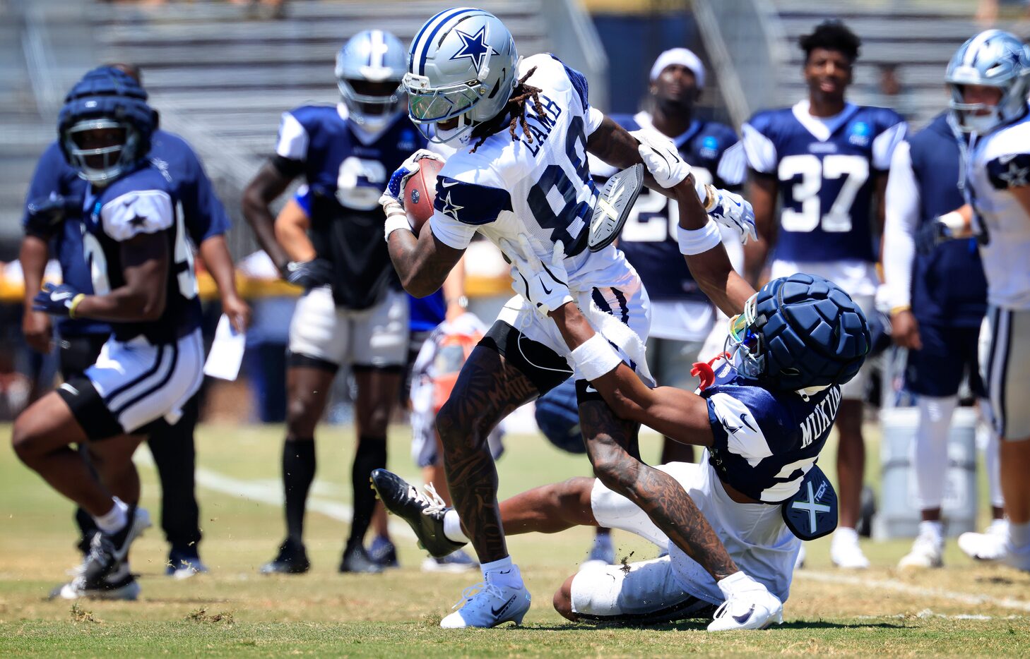 Dallas Cowboys wide receiver CeeDee Lamb (88) shakes safety Israel Mukuamu (24) after making...