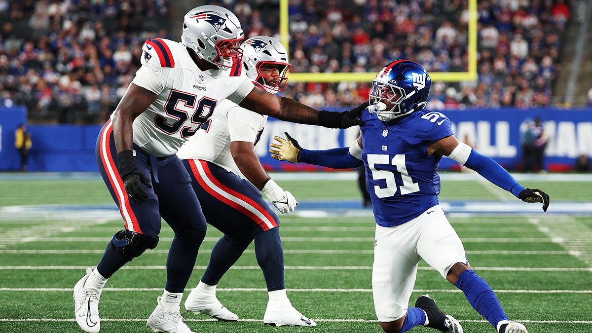 Abdul Carter #51 of the New York Giants rushes against Vederian Lowe #59 of the New England Patriots during a preseason game at MetLife Stadium.