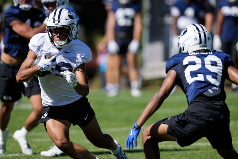BYU receiver Tiger Bachmeier carries the ball after making a catch during Day 3 of fall camp in Provo, Friday, Aug. 1, 2025.