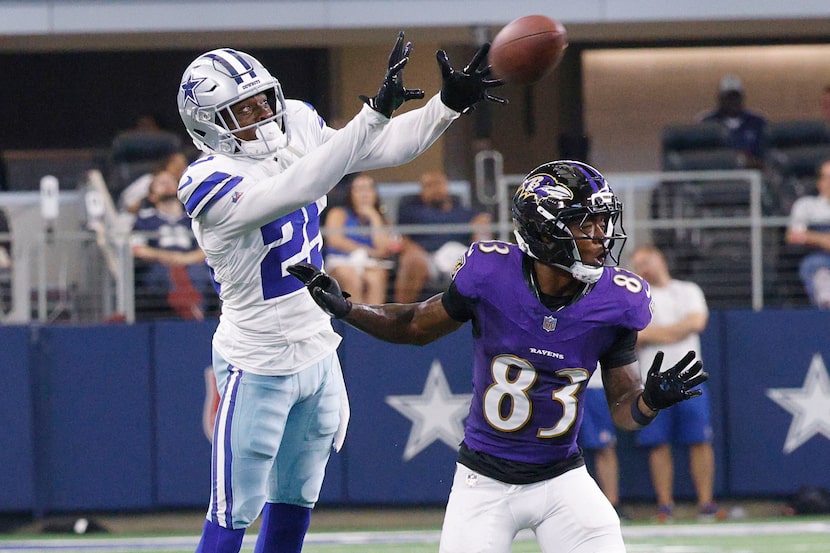 Dallas Cowboys cornerback Andrew Booth (25) intercepts a pass intended for Baltimore Ravens...