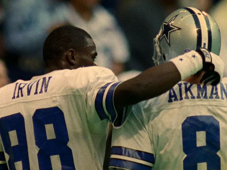Michael Irvin and Troy Aikman in a still from 