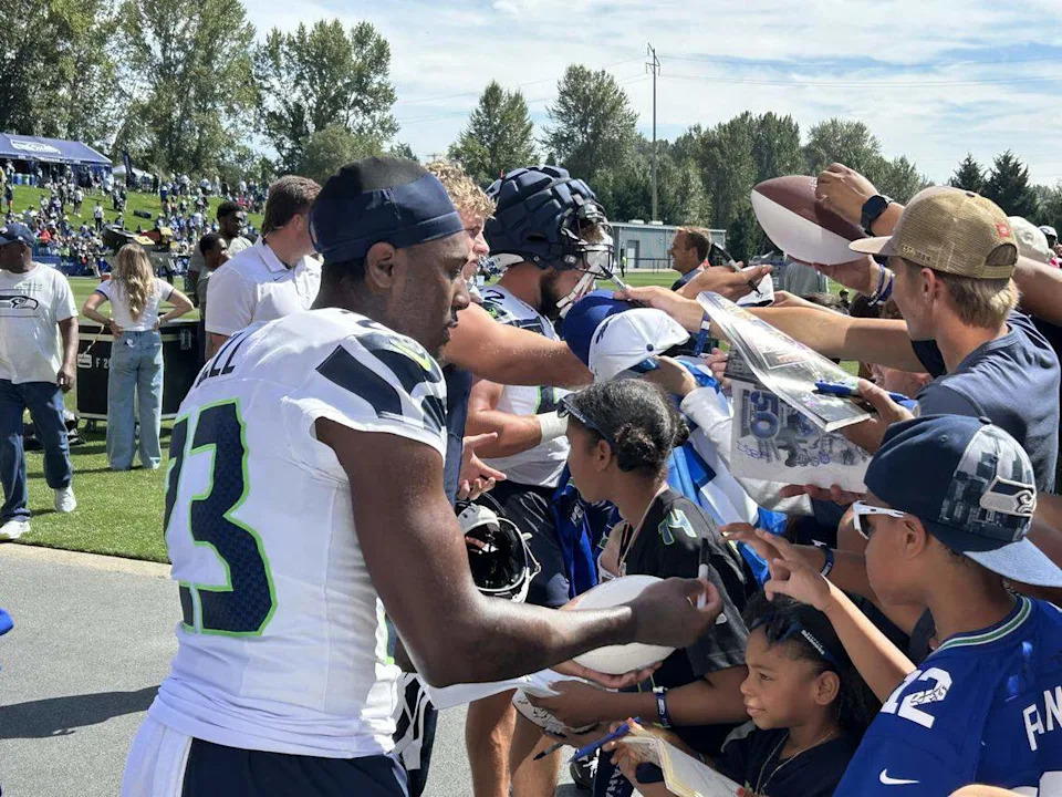 New Seahawks safety D’Anthony Bell, formerly with the Cleveland Browns, signs autographs for young fans following the fourth practice of Seattle’s NFL training camp Saturday, July 26, 2025, at the Virginia Mason Athletic Center in Renton.