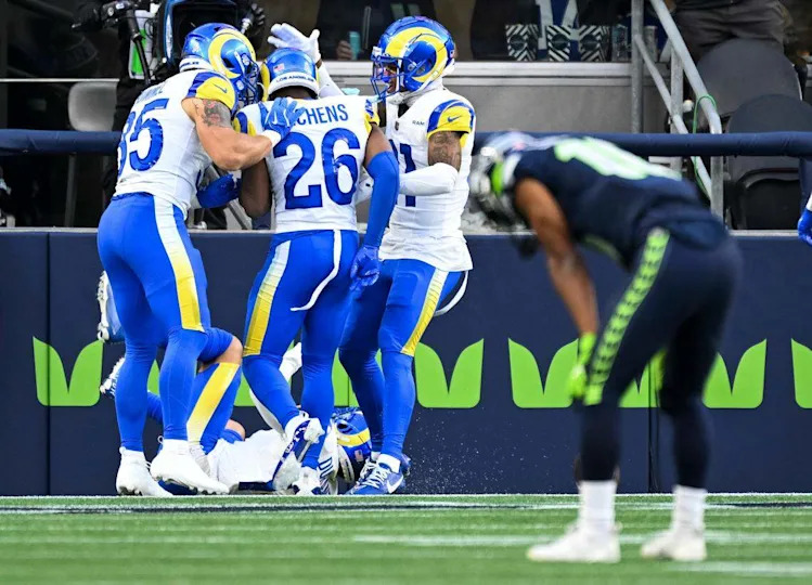 Los Angeles Rams cornerback Darious Williams (24) and teammates celebrate an interception of Seahawks quarterback Geno Smith that Williams returned 103 yards for a touchdown during the fourth quarter of the game at Lumen Field Sunday, Nov. 3, 2024 in Seattle.