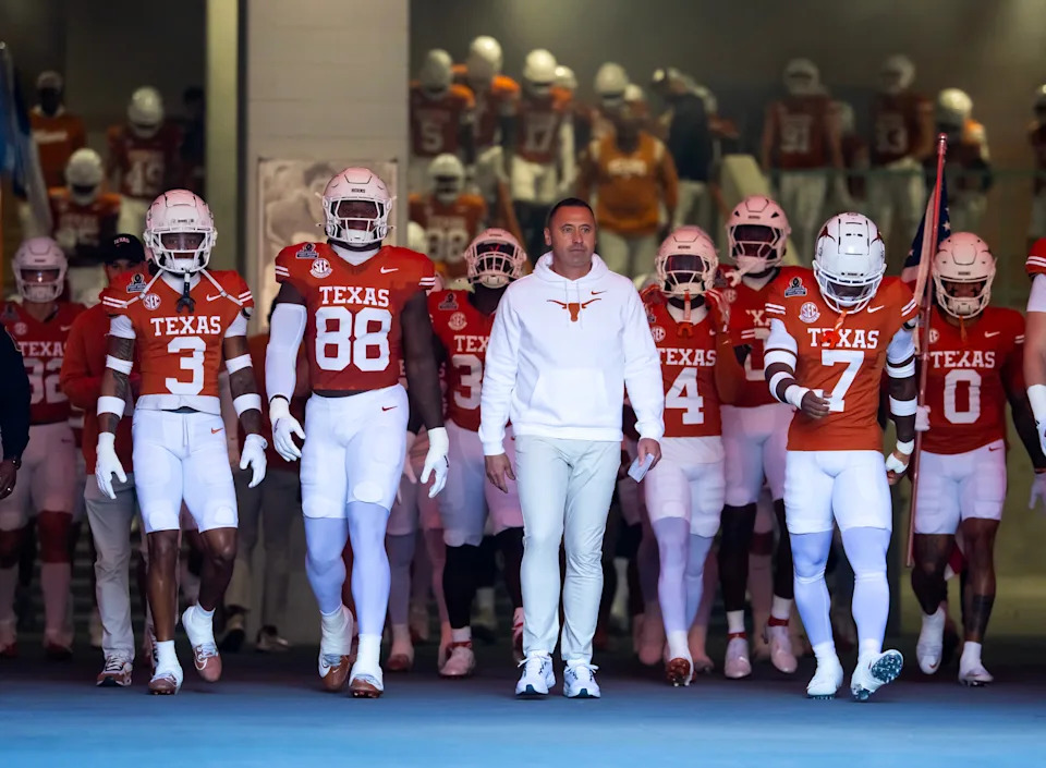 Dec 21, 2024; Austin, Texas, USA; Texas Longhorns head coach Steve Sarkisian leads his team onto the field prior to the game against the Clemson Tigers during the CFP National playoff first round at Darrell K Royal-Texas Memorial Stadium. Mandatory Credit: Mark J. Rebilas-Imagn Images