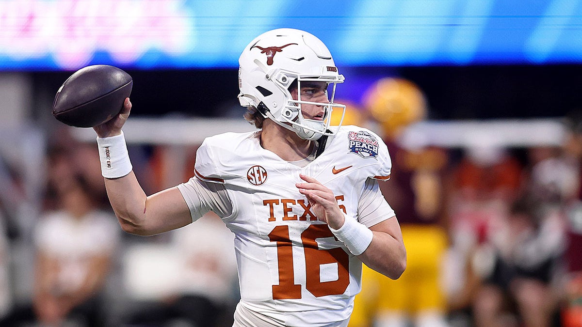 Arch Manning warms up