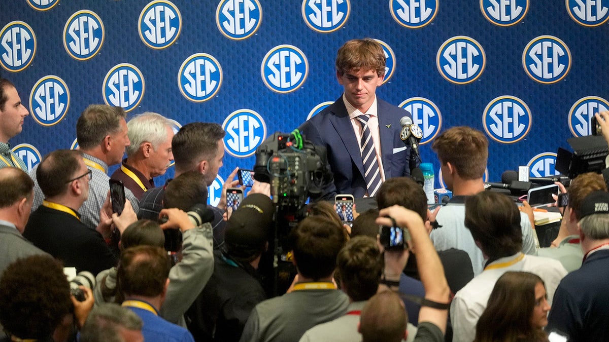 Arch Manning surrounded by media