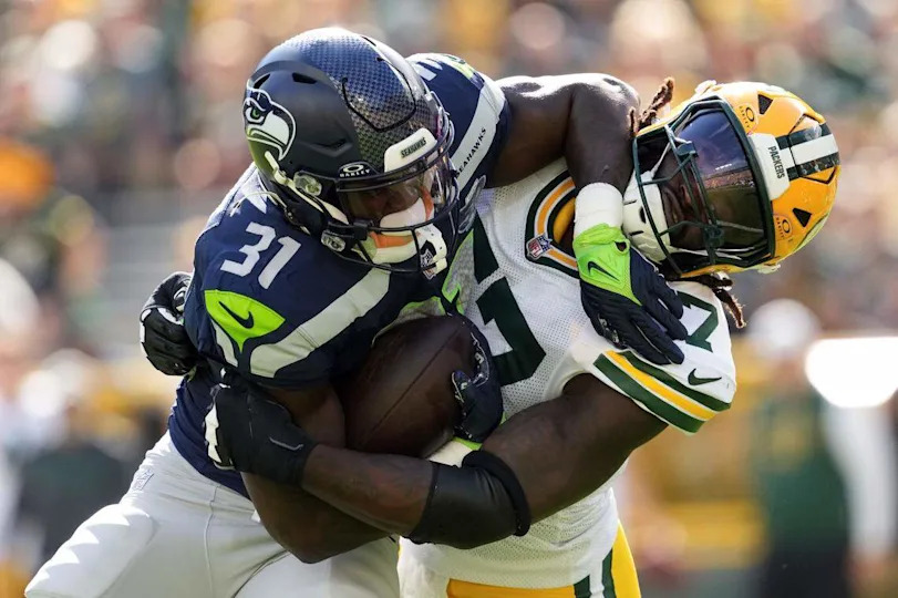 Green Bay Packers defensive lineman Brenton Cox Jr. (57) tackles Seattle Seahawks running back Jacardia Wright (31) during the second quarter at Lambeau Field. Mandatory Credit: Jeff Hanisch-Imagn Images Jeff Hanisch/USA TODAY NETWORK