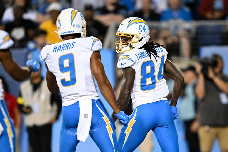 KeAndre Lambert-Smith and Tre' Harris of the Chargers celebrate a 15-yard touchdown catch by Lambert-Smith.