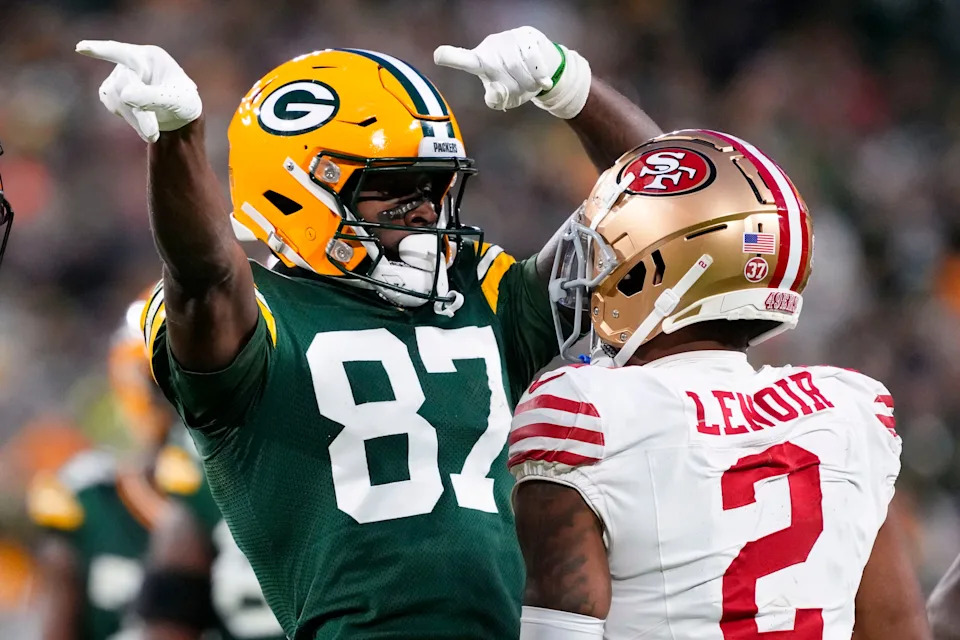Nov 24, 2024; Green Bay, Wisconsin, USA; Green Bay Packers wide receiver Romeo Doubs (87) celebrates in front of San Francisco 49ers cornerback Deommodore Lenoir (2) after earning a first down during the second quarter at Lambeau Field. Mandatory Credit: Jeff Hanisch-Imagn Images