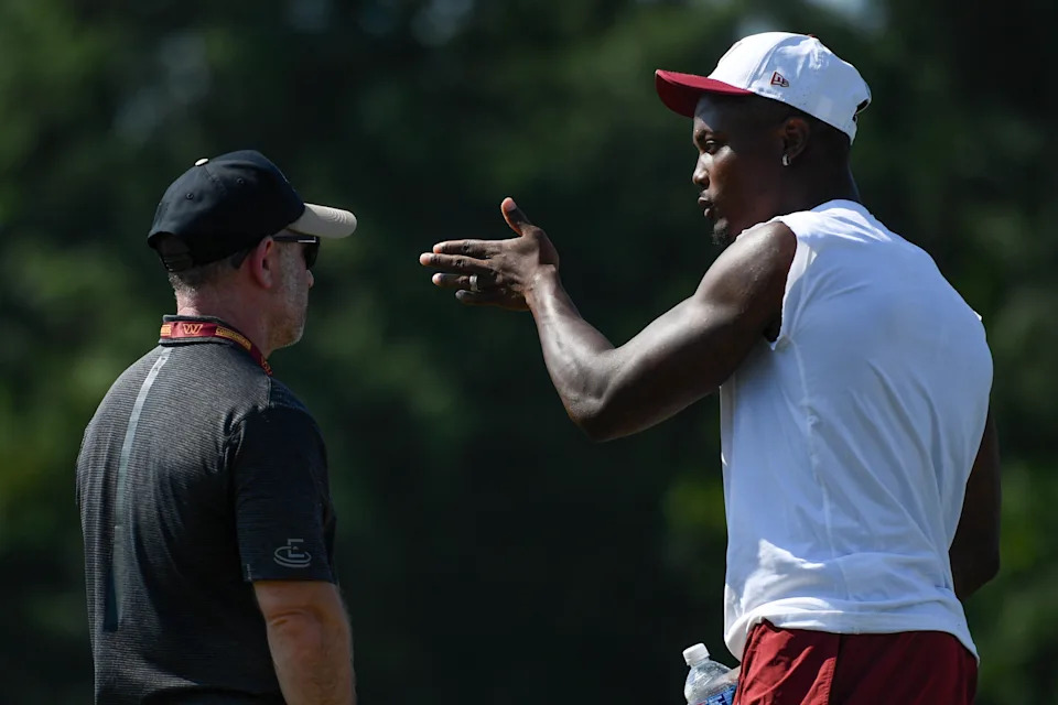 ASHBURN, VA - JULY 27: Washington Commanders wide receiver Terry McLaurin (17) speaks to his agent Buddy Baker during training camp on Sunday, July 27, 2025. (Photo by Hannah Foslien/For The Washington Post via Getty Images)