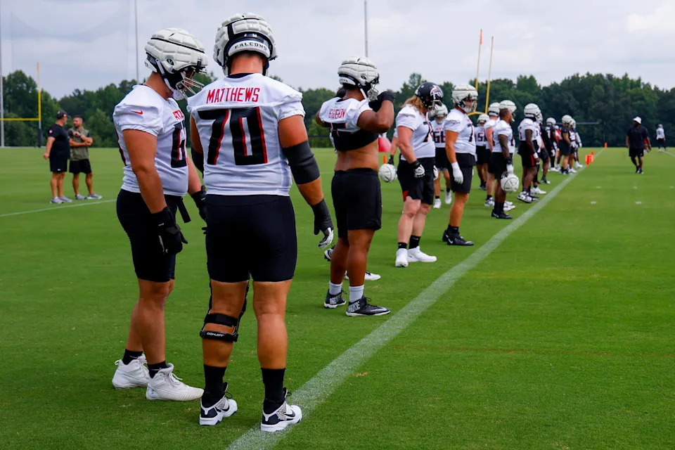 FLOWERY BRANCH, GEORGIA - JULY 28: Jake Matthews #70 and Chris Lindstrom #63 of the Atlanta Falcons line up with other lineman during training camp on July 28, 2024 in Flowery Branch, Georgia. (Photo by Todd Kirkland/Getty Images)