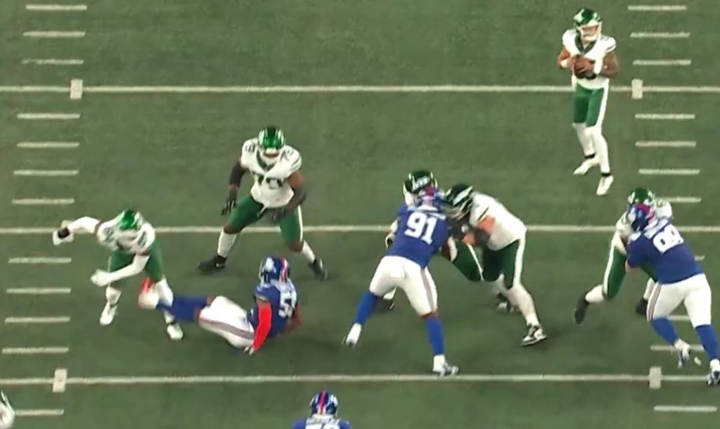 Abdul Carter (51) is put on the ground from a chip block by Jets tight end Stone Smartt (84) on Aug. 16, 2025.